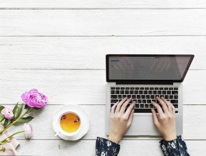 woman typing on laptop